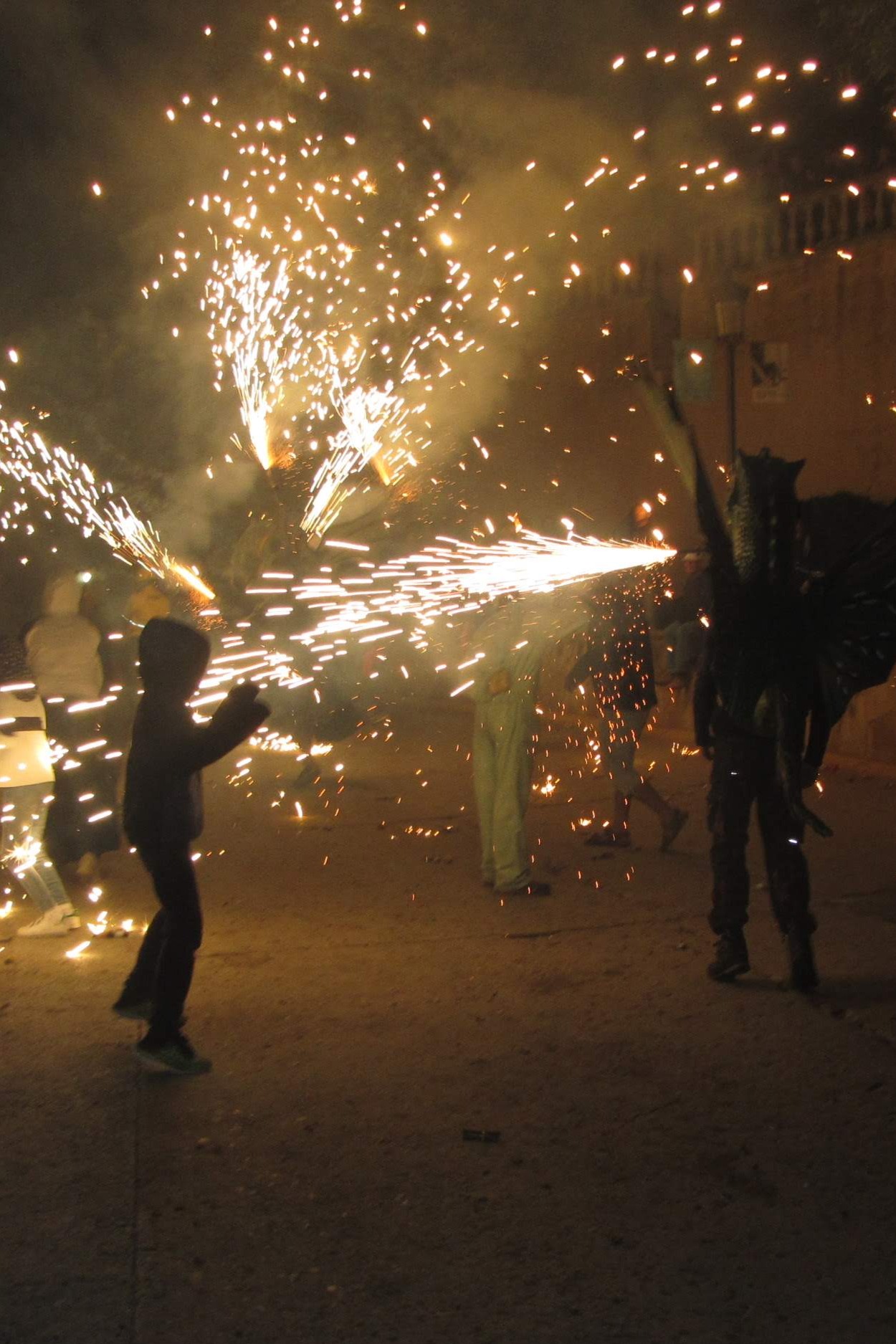 "Diables" throw fireworks and a dragon, or Drac, spits flame during a traditional Catalan Correfoc. Photo © Dugald Steer 2019.