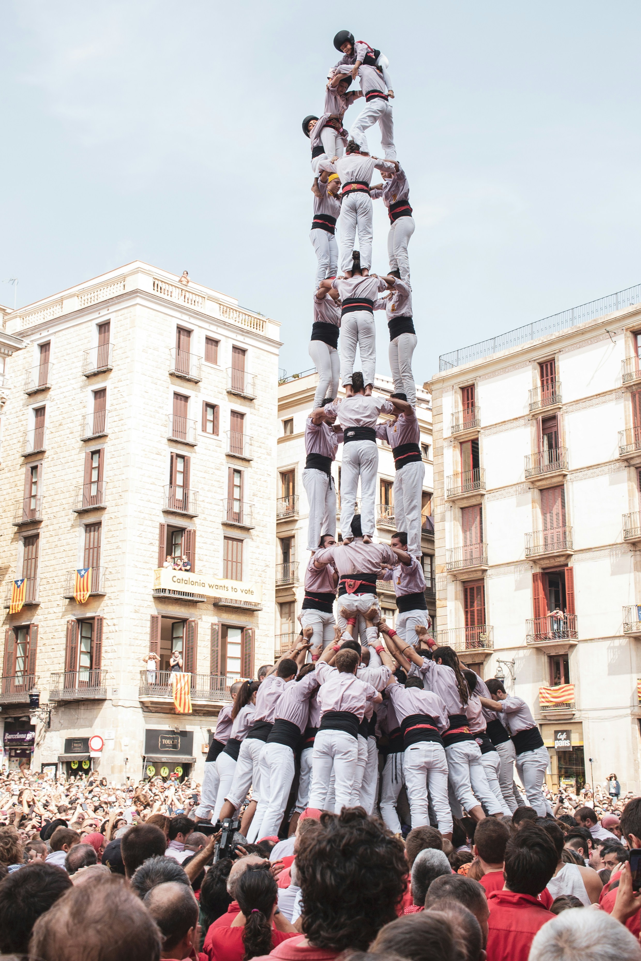 A photo of people building a "Castell" or human pyramid in Catalonia, courtesy of Angela Compagnone on www.unsplash.com.